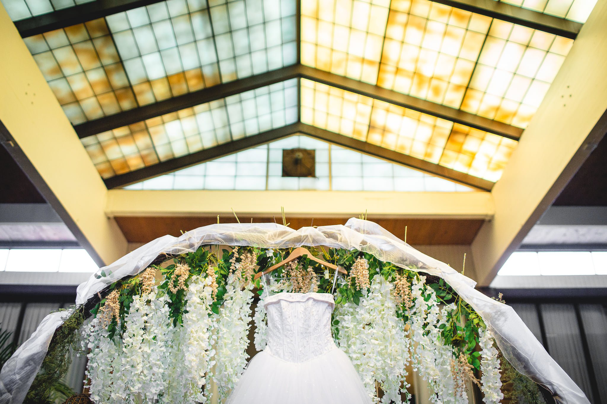 Wedding dress in-front of flower wreath
