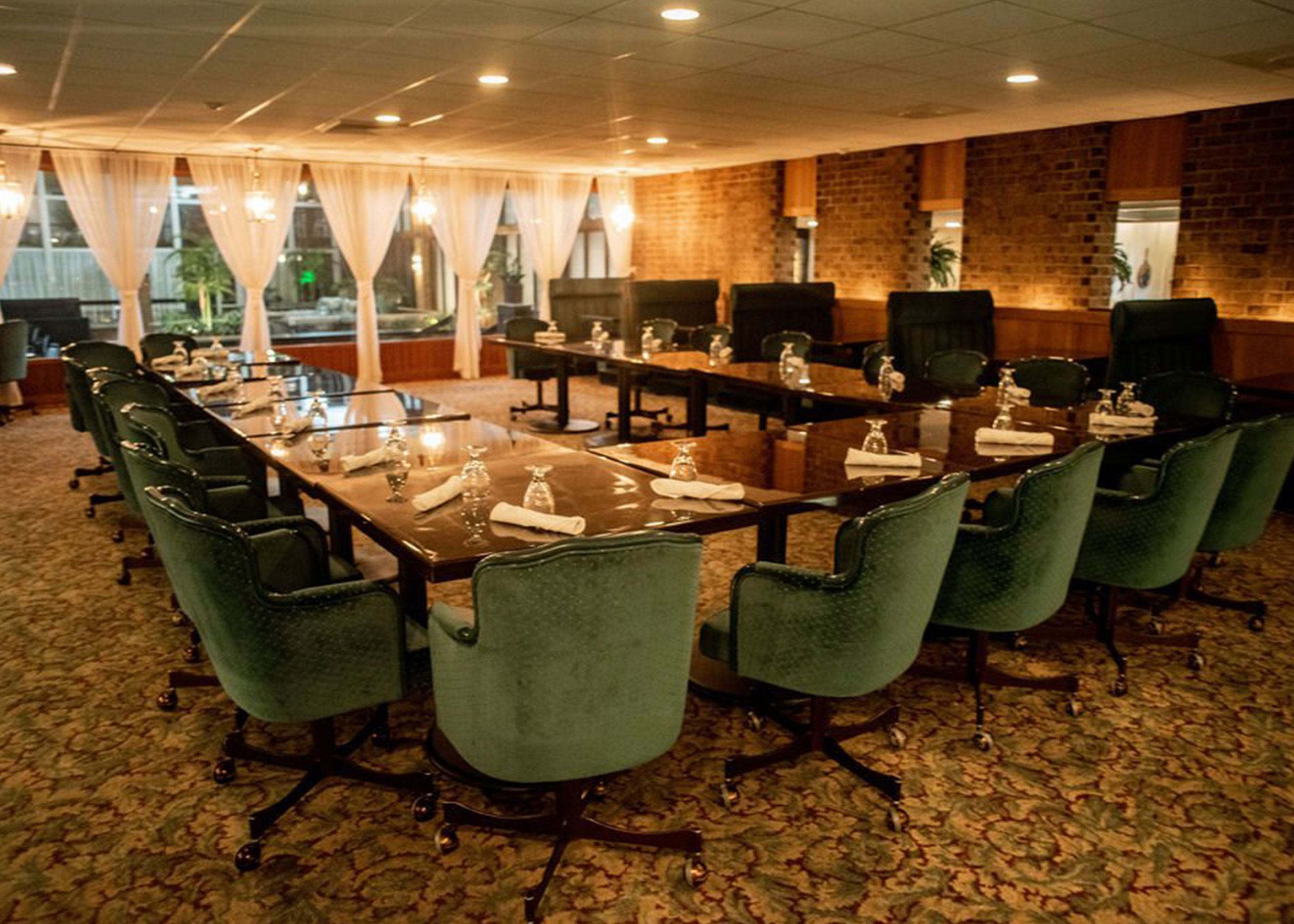 Meeting area Large U shaped table with silverware and glasses