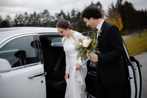 Bride and Groom entering a vehicle
